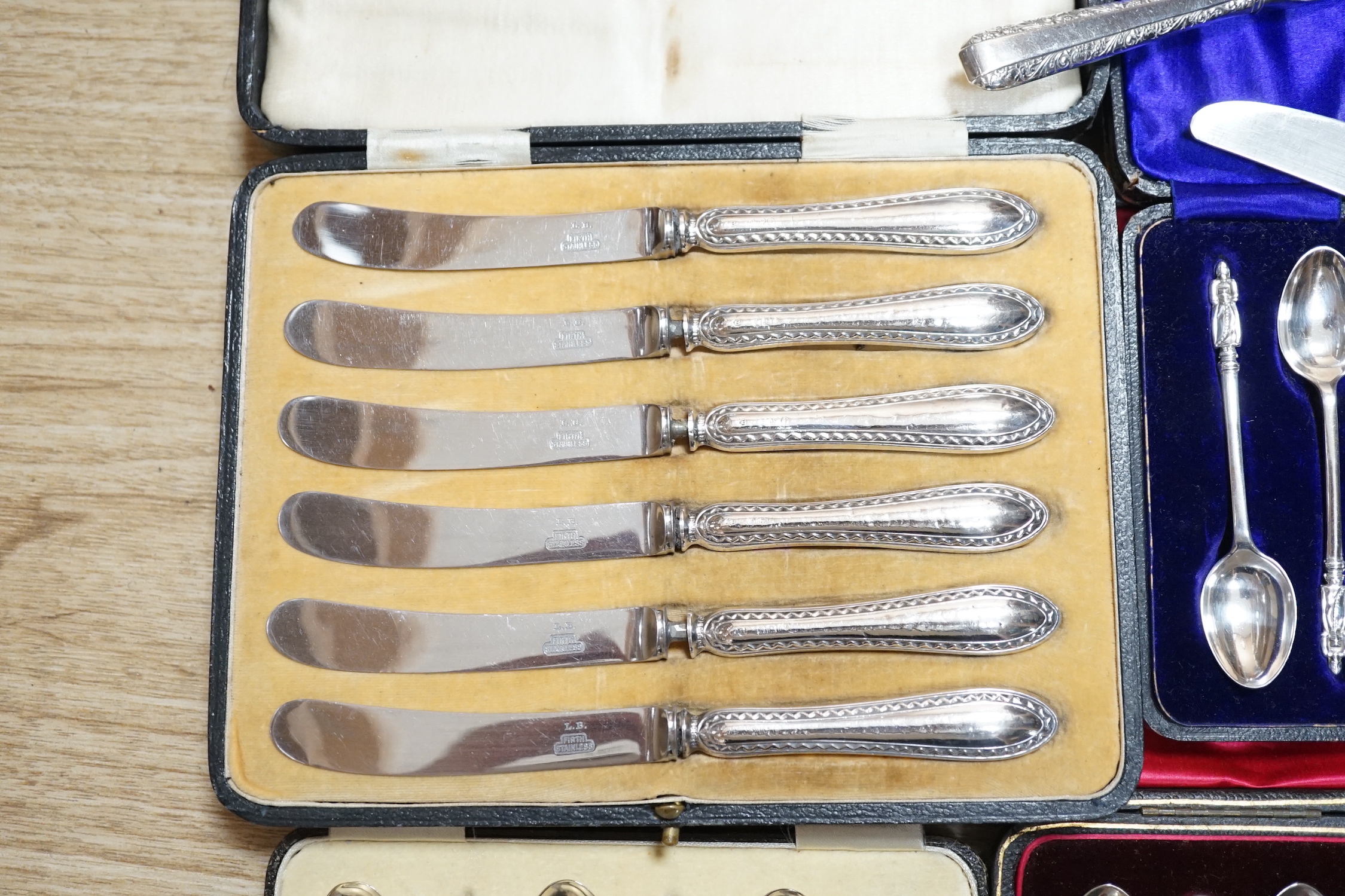 A cased set of six George V silver and polychrome enamel coffee spoons, Barker Brothers Silver Ltd, Birmingham, 1932, four other cased sets including teaspoons and tea knives and seventeen assorted Towle sterling handled